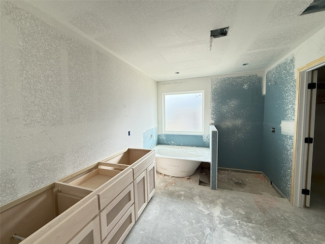 bathroom featuring a bath and concrete flooring