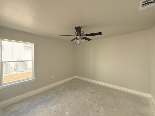 spare room with ceiling fan, concrete floors, and a textured ceiling