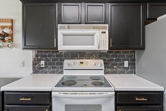 kitchen featuring white appliances and tasteful backsplash