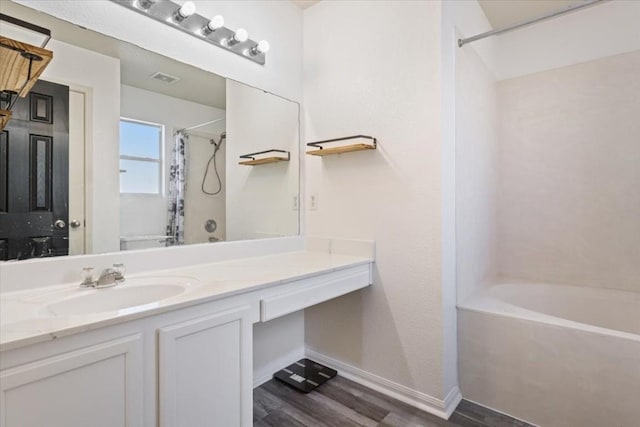 bathroom featuring vanity, wood-type flooring, and shower / bath combo