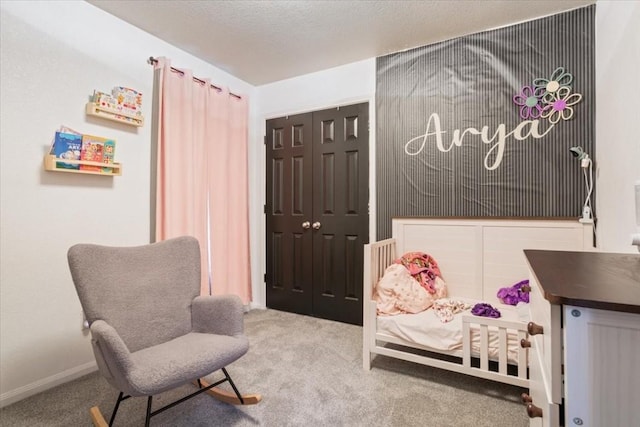 bedroom featuring a closet, carpet floors, and a textured ceiling