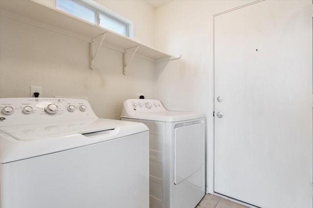 laundry room featuring independent washer and dryer and light tile patterned floors