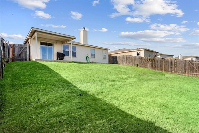 rear view of house featuring a lawn