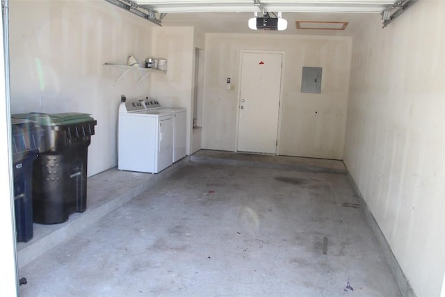 garage with electric panel, washer and dryer, and a garage door opener