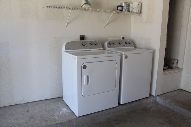 clothes washing area with separate washer and dryer