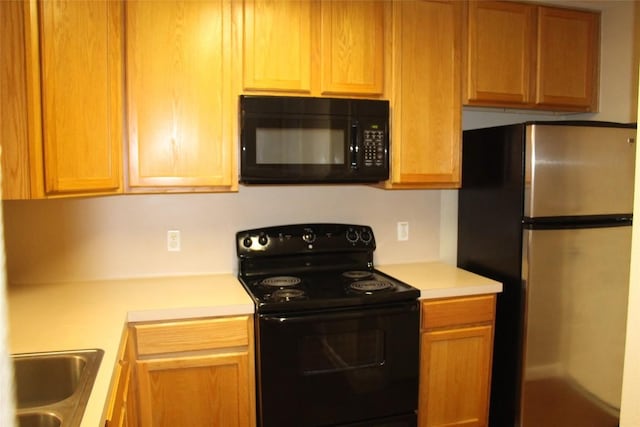 kitchen with sink and black appliances