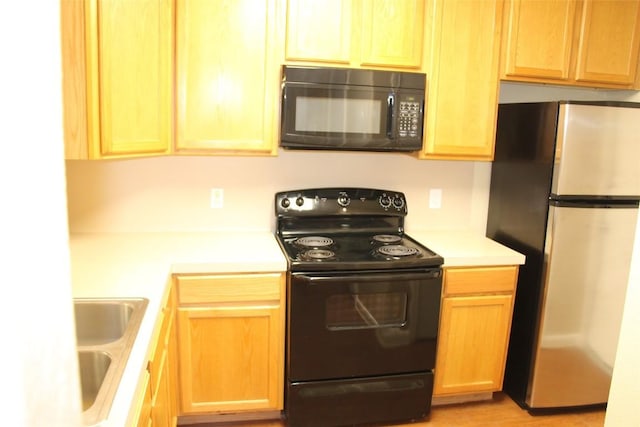 kitchen with sink and black appliances