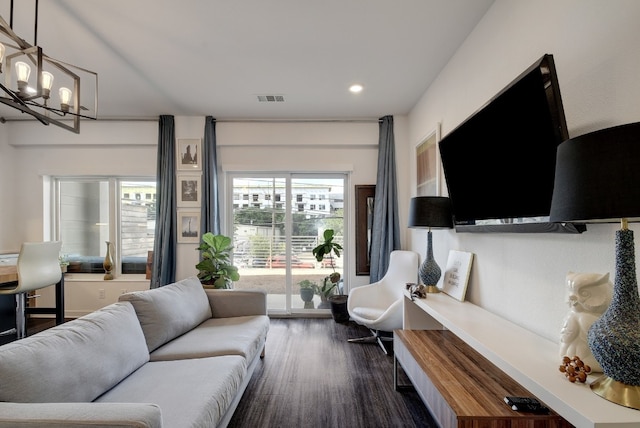 living room featuring dark hardwood / wood-style floors and a notable chandelier