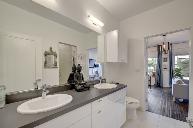 bathroom with toilet, vanity, and hardwood / wood-style flooring