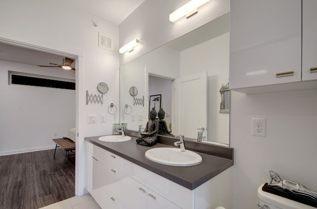 bathroom with ceiling fan, hardwood / wood-style floors, vanity, and toilet