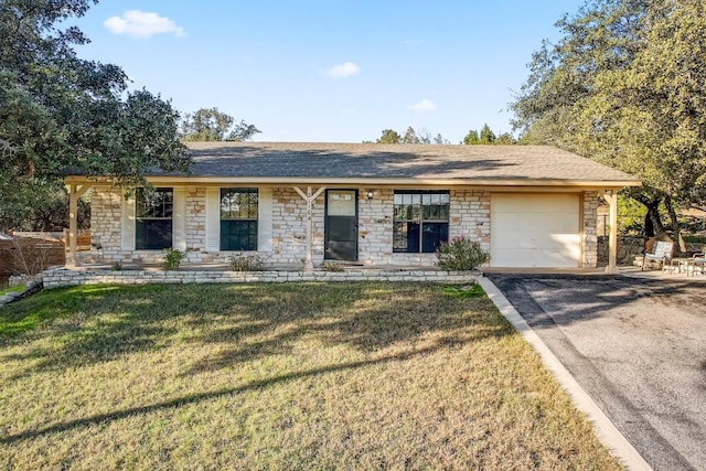 single story home featuring a garage and a front yard