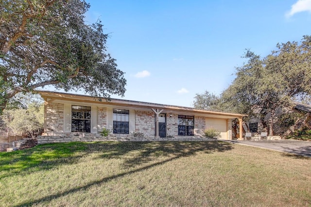 ranch-style home with a garage and a front lawn