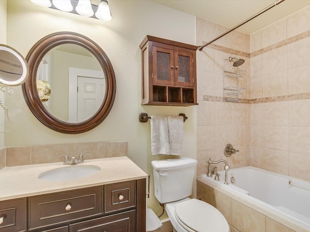 full bathroom with vanity, toilet, and tiled shower / bath