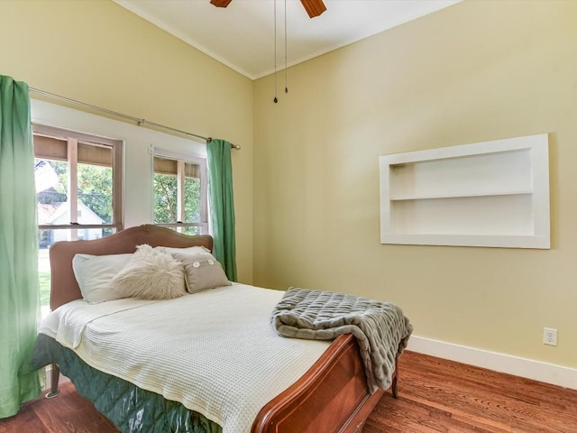 bedroom featuring ceiling fan, crown molding, and hardwood / wood-style flooring