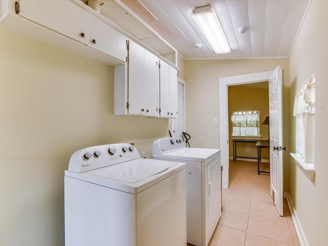 laundry area with separate washer and dryer, crown molding, light tile patterned flooring, and cabinets