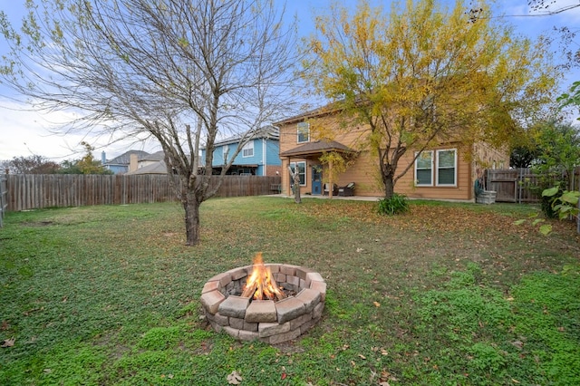 view of yard with a fire pit