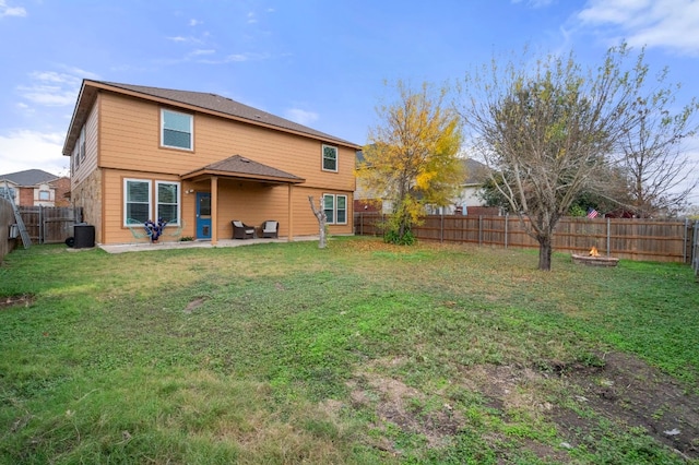 rear view of house with a patio area and a lawn