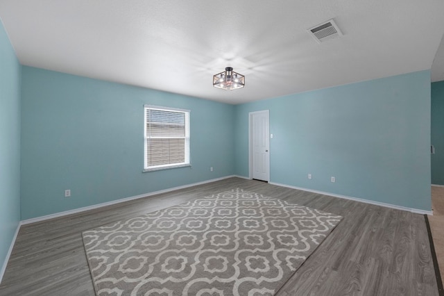 spare room featuring dark hardwood / wood-style floors