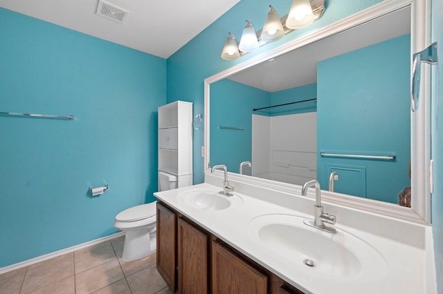 bathroom featuring vanity, toilet, a shower, and tile patterned floors