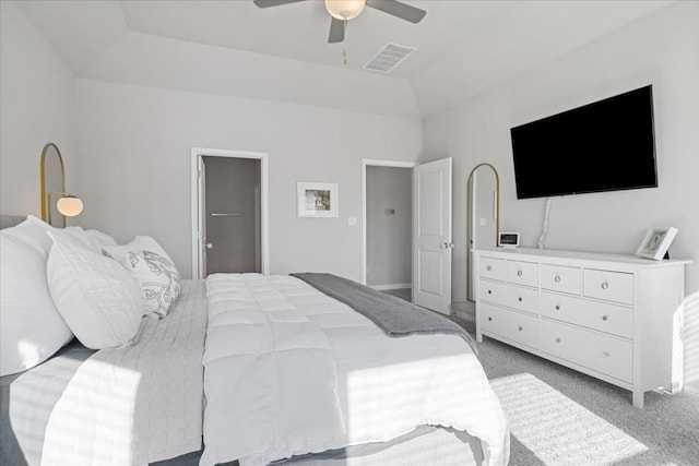 carpeted bedroom featuring a spacious closet, ceiling fan, and lofted ceiling