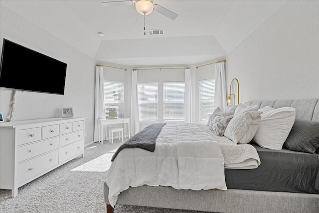 bedroom with ceiling fan, light colored carpet, and vaulted ceiling