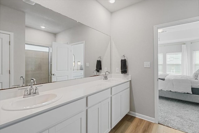 bathroom featuring hardwood / wood-style floors, vanity, and an enclosed shower