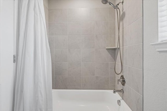 bathroom with shower / bath combo with shower curtain