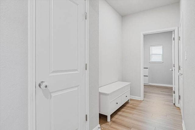 corridor with light hardwood / wood-style floors