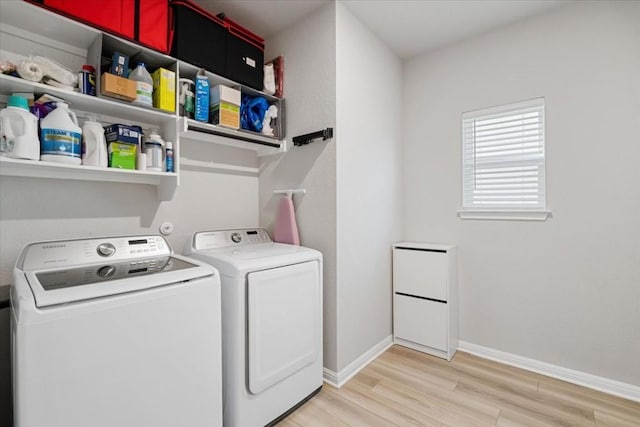 clothes washing area with light hardwood / wood-style floors and independent washer and dryer