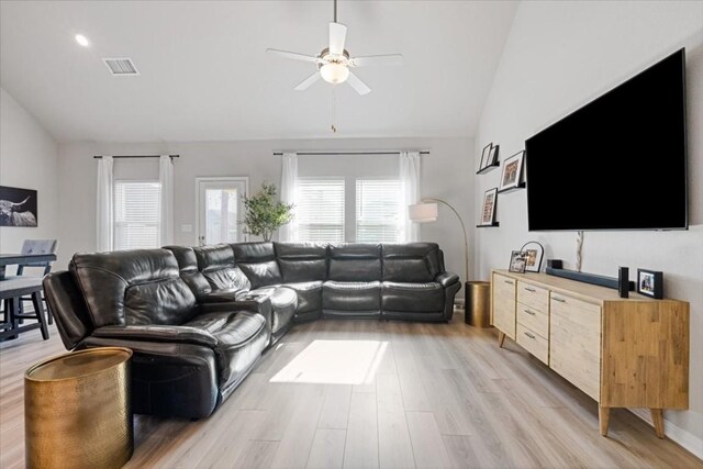 living room with light wood-type flooring, ceiling fan, and lofted ceiling