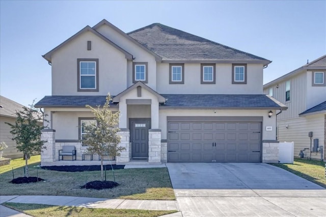 view of front of property with driveway, stone siding, a garage, and stucco siding