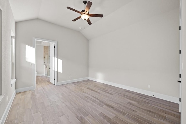 empty room with lofted ceiling, ceiling fan, and light hardwood / wood-style flooring