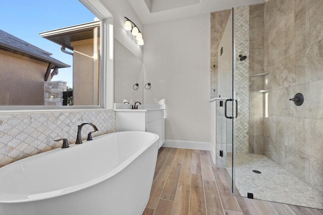 bathroom featuring separate shower and tub, decorative backsplash, vanity, and wood-type flooring