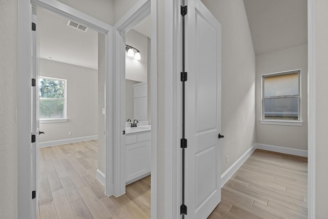 hallway with light hardwood / wood-style flooring