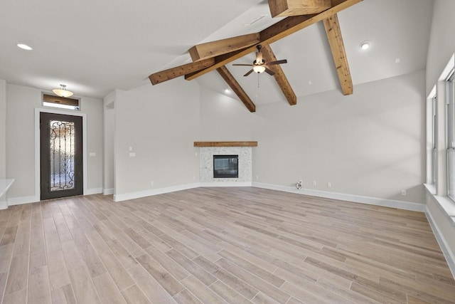 unfurnished living room featuring beamed ceiling, ceiling fan, light hardwood / wood-style floors, and high vaulted ceiling