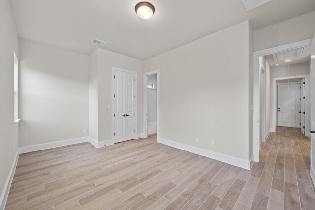 spare room with light hardwood / wood-style flooring