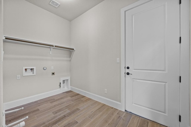 604 Bottlebrush Dr, Georgetown, TX 78628 - washroom featuring hookup for a gas dryer, hookup for an electric dryer, light wood-type flooring, and hookup for a washing machine
