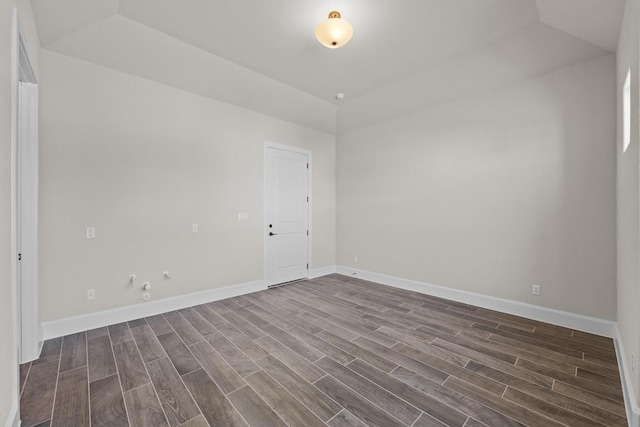 empty room with dark hardwood / wood-style flooring