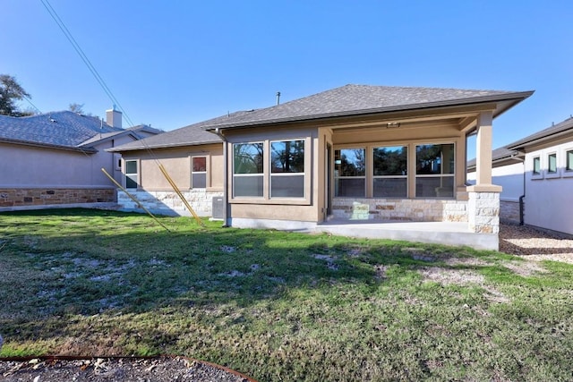 rear view of house featuring a yard