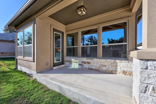 entrance to property with a patio