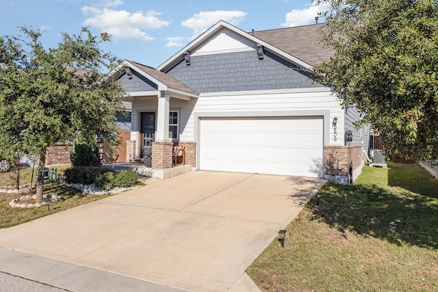 craftsman house featuring a garage, central air condition unit, and a front yard