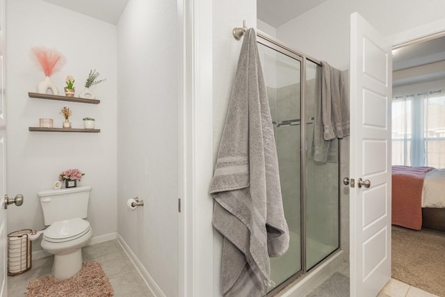 full bathroom with ensuite bathroom, toilet, baseboards, a shower stall, and tile patterned floors