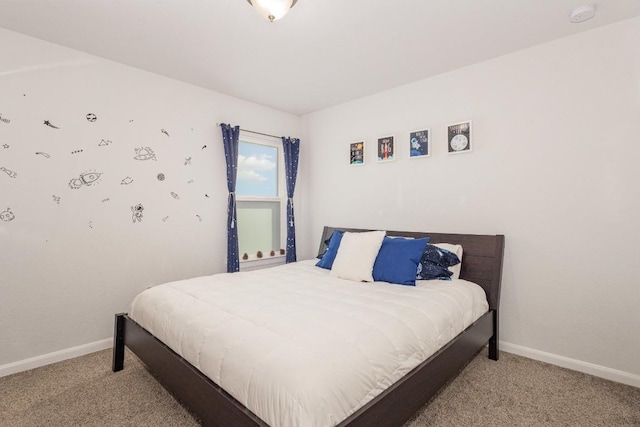 bedroom with light carpet and baseboards