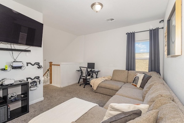 carpeted living area featuring visible vents and baseboards