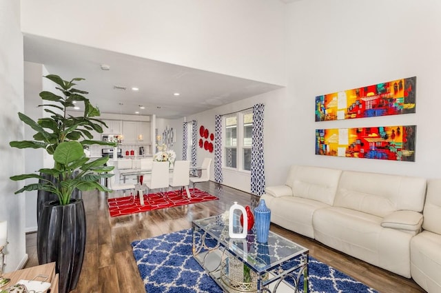 living area featuring recessed lighting and dark wood finished floors