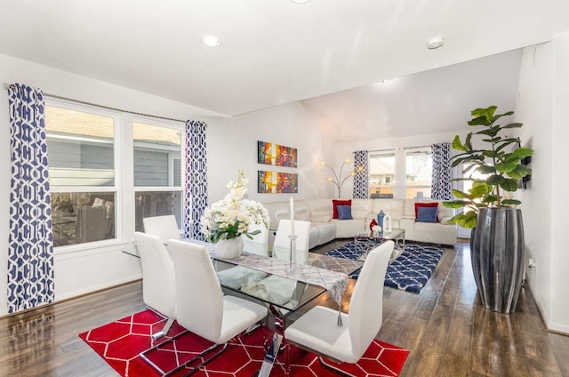 dining space with lofted ceiling, baseboards, and dark wood-style flooring