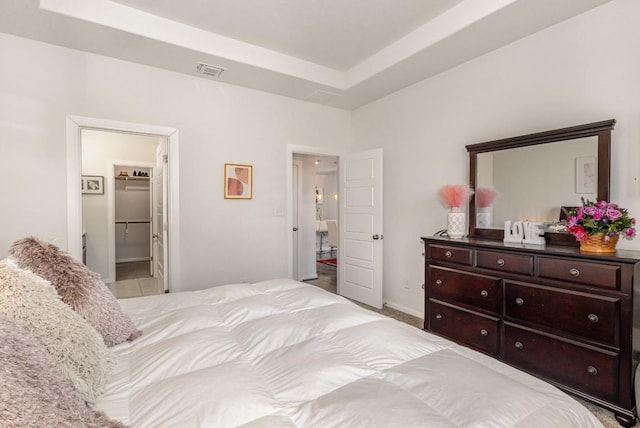 bedroom with visible vents and a raised ceiling