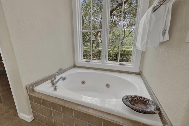 bathroom featuring tiled bath and tile patterned floors