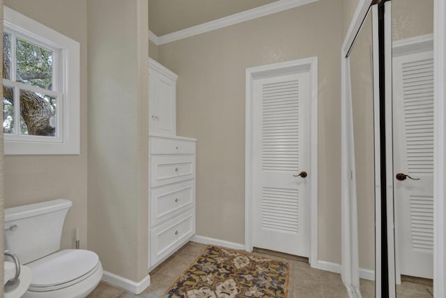 bathroom featuring tile patterned floors, toilet, and ornamental molding