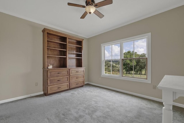 unfurnished bedroom with ceiling fan, crown molding, and light colored carpet